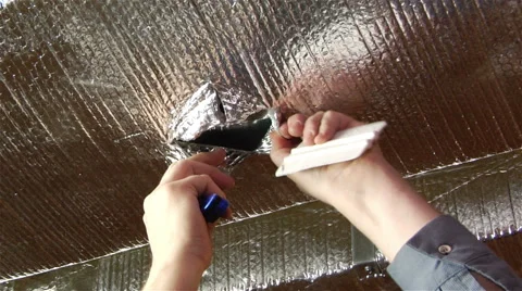 Worker makes cuts in unit insulation Stock Footage 42957636