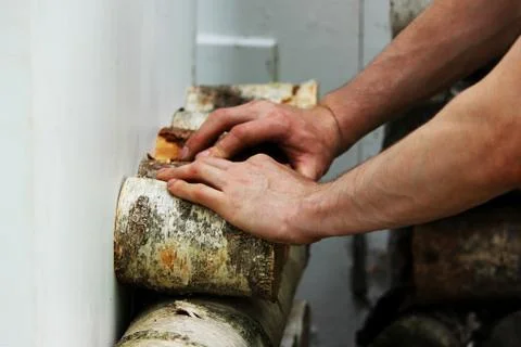 The worker makes the decor on the shutters of the window. Fastening pieces of Stock Photos