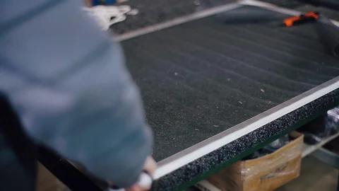 Worker makes a details for window Stockbeeldmateriaal 129367463