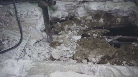 Worker makes a hole in the floor and flies fly around Stock Footage 110800741