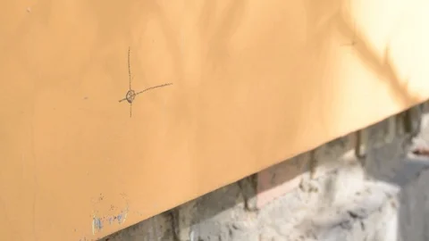 Worker makes a hole in a wall using a perforator Stock Footage 87794746