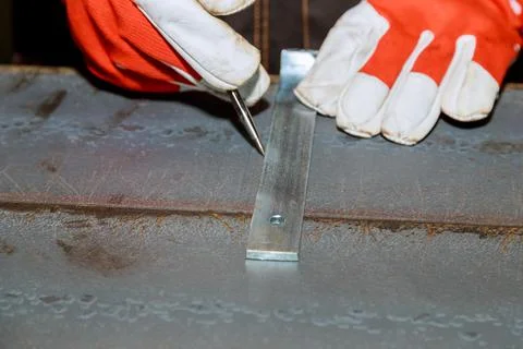 The worker makes a mark on a metal surface by means of Measuring square Stock Photos