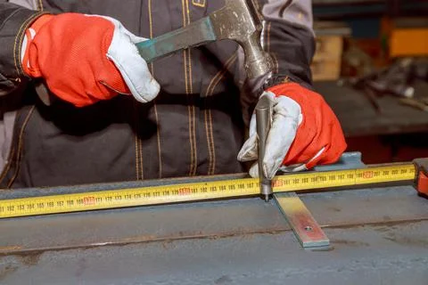 The worker makes a mark on a metal surface by means of Measuring square Stock Photos