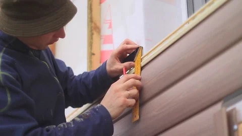 The worker makes the markup on the facade Stock Footage 80209916