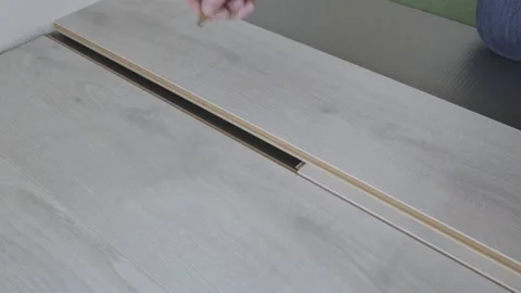 A worker makes a markup with a pencil and a square on the laminate panel Stock Footage 147172972