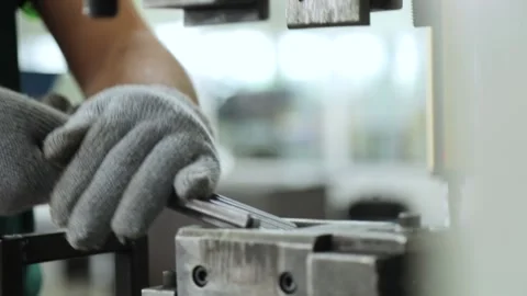 Worker makes metal parts using a bending machine Stock Footage 162914609