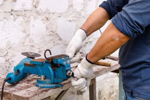 Worker makes repairs  with electric tools  hammer and  pliers in backyard Stock Photos