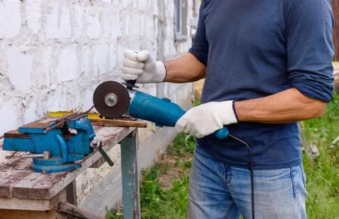 Worker makes repairs  with electric tools  hammer and  pliers in backyard Stock Photos