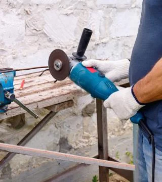 Worker makes repairs  with electric tools  hammer and  pliers in backyard Stock Photos