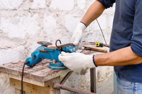 Worker makes repairs  with electric tools  hammer and  pliers in backyard Stock Photos