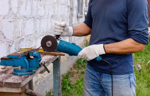 Worker makes repairs  with electric tools  hammer and  pliers in backyard Stock Photos
