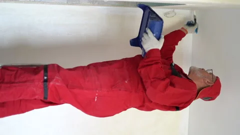 Worker makes repairs, video for stories. Vertical video of a mature gray-bearded Stock Footage 167227393