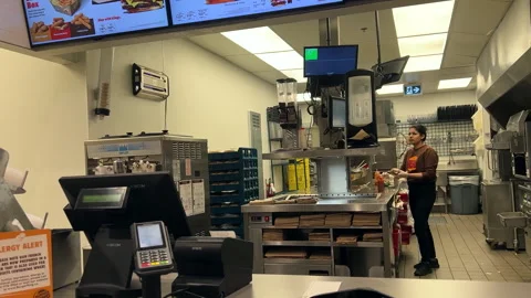 Worker making burgers for the customer inside Burger Kings with 4k resolution Stock Footage 280293231