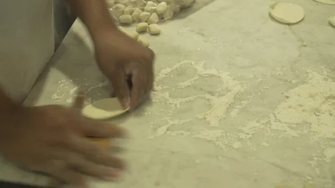 Worker making dumplings with hands.  Video stock 78884166