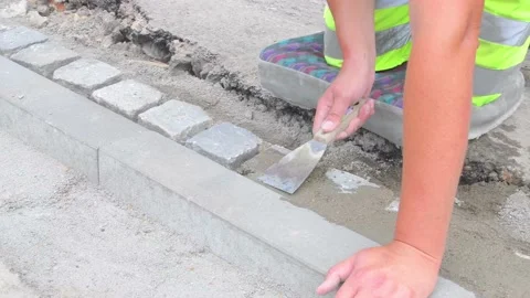 Worker making final work before arriving road finisher. Bulding worker on Stock Footage 156824494