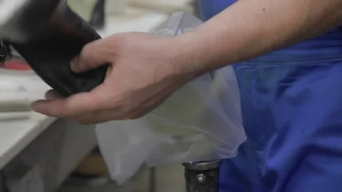 Worker making leather shoes on production line conveyor in production line of Stock Footage 155392338