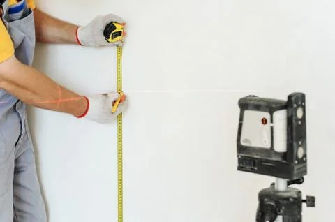 Worker making measurement. Stock Photos
