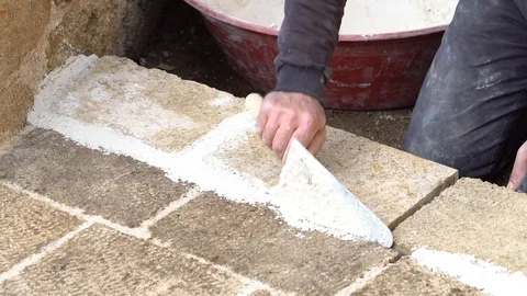 Worker making new sidewalk pavement with stone bricks. Stock Footage 85590097