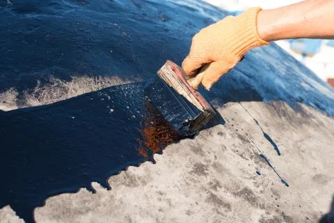 Worker making waterproofing. Stock Photos