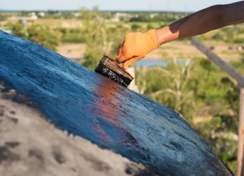 Worker making waterproofing. Stock Photos