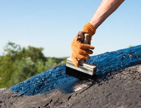 Worker making waterproofing. Stock Photos
