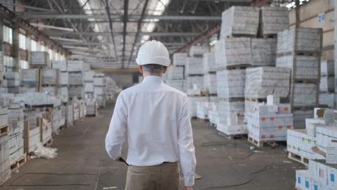 Worker male warehouse worker engineer man in a helmet working on the Stock Footage 114443207