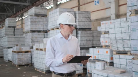 Worker male warehouse worker engineer man in a helmet working on the Stock Footage 114443457