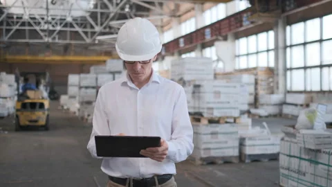 Worker male warehouse worker engineer man in a helmet working on the Stock Footage 114445708