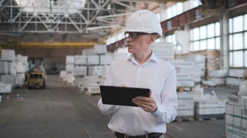 Worker male warehouse worker engineer man in a helmet working on the Stock Footage 114446047