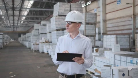 Worker male warehouse worker engineer man in a helmet working on the Stock Footage 114446549