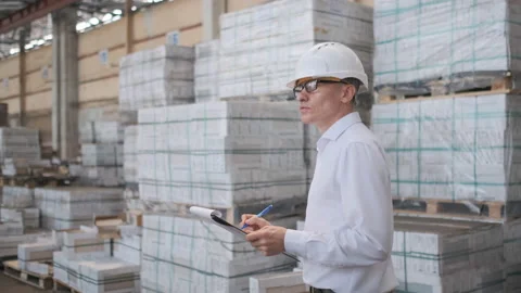 Worker male warehouse worker engineer man in a helmet working on the Video stock 114447479