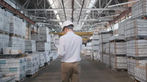 Worker male warehouse worker engineer man in a helmet working on the Video stock 114448429
