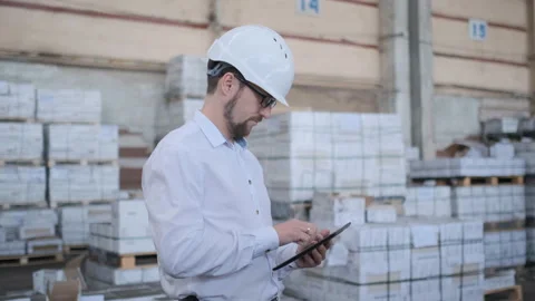 Worker male warehouse worker engineer man in a helmet working on the Video stock 114450895