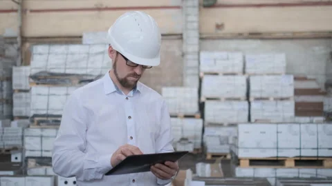 Worker male warehouse worker engineer man in a helmet working on the Video stock 114451100