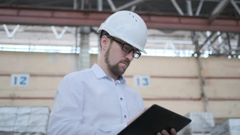 Worker male warehouse worker engineer man in a helmet working on the Video stock 114451339