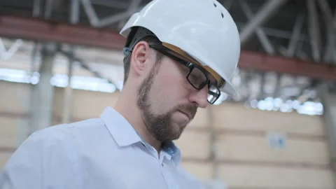 Worker male warehouse worker engineer man in a helmet working on the Video stock 114451447