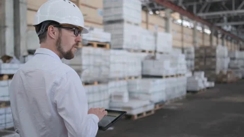 Worker male warehouse worker engineer man in a helmet working on the Video stock 114451531