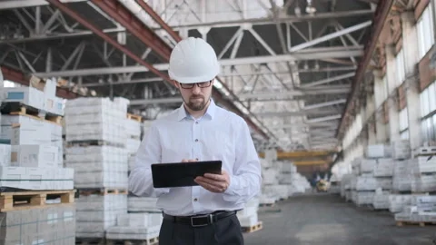 Worker male warehouse worker engineer man in a helmet working on the Video stock 114451666