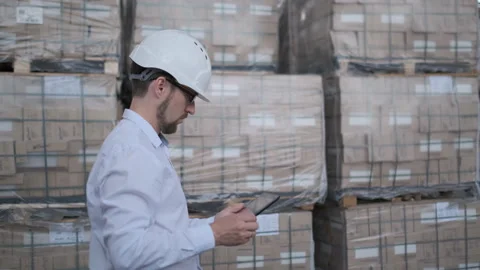 Worker male warehouse worker engineer man in a helmet working on the Video stock 114452004