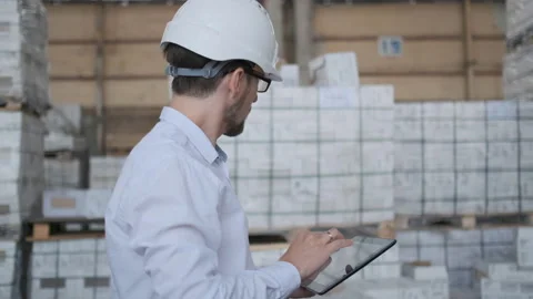 Worker male warehouse worker engineer man in a helmet working on the Video stock 114452187