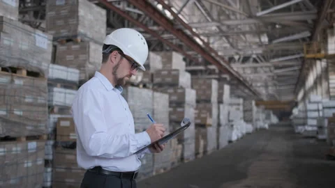 Worker male warehouse worker engineer man in a helmet working on the Video stock 114452365