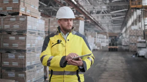 Worker male warehouse worker engineer man in a helmet working on the Video stock 114472703