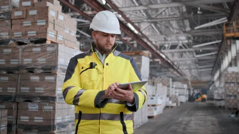 Worker male warehouse worker engineer man in a helmet working on the Video stock 114472713