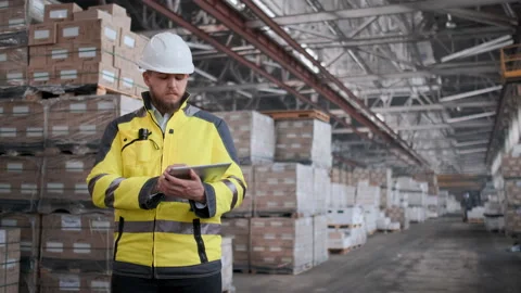 Worker male warehouse worker engineer man in a helmet working on the Video stock 114472775