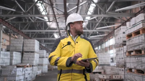 Worker male warehouse worker engineer man in a helmet working on the Stock Footage 114473686