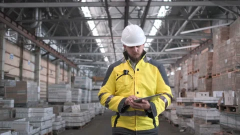 Worker male warehouse worker engineer man in a helmet working on the Stock Footage 114473887