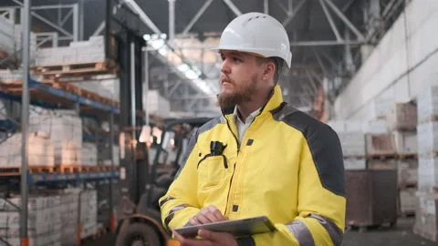 Worker male warehouse worker engineer man in a helmet working on the Video stock 114474009