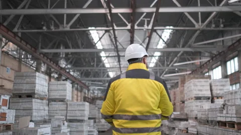 Worker male warehouse worker engineer man in a helmet working on the Stock Footage 114474010