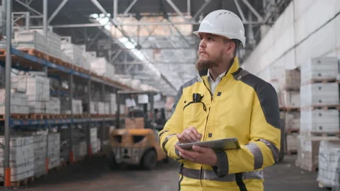 Worker male warehouse worker engineer man in a helmet working on the Stock Footage 114474087