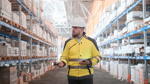 Worker male warehouse worker engineer man in a helmet working on the Stock Footage 114474453
